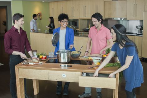 The FirstBuild team interacts with The Louisville Table, FirstBuild’s first artist–in-corporate-residence-created product.