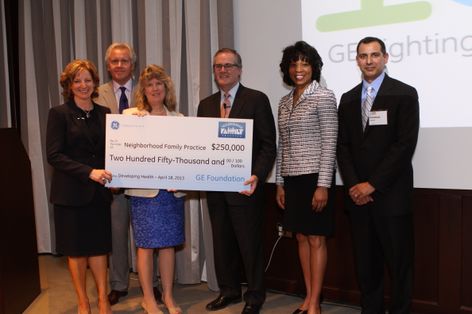 GE Lighting President and CEO, Maryrose Sylvester, presents donation on behalf of the GE Foundation to Neighborhood Family Practice.