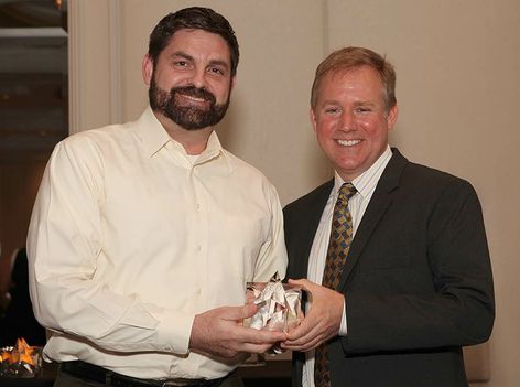 Jim Benson, GE Lighting’s GM Global Professional Marketing, accepts three tED magazine Best of the Best Awards from Shad Thomas, a judge and awards ceremony presenter for the 2014 Best of the Best Annual Marketing Competition.