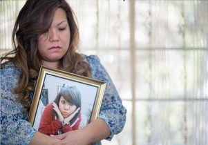 Jeannie Malabanan hugs a protrait of her daughter Ashlee, who died this year of cancer.