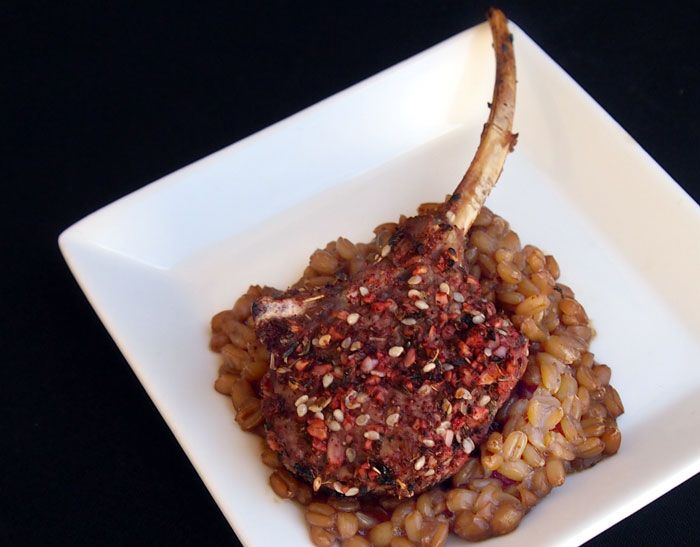 Grilled Persian-style lamb chops on a bed of cooked spelt