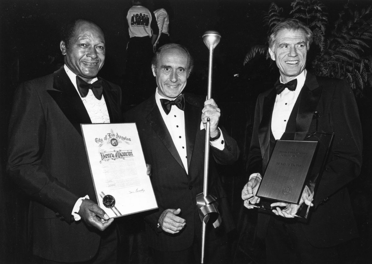 UCLA alumnus and Los Angeles Mayor Tom Bradley; composer Henry Mancini; UCLA Chancellor Charles E. Young.