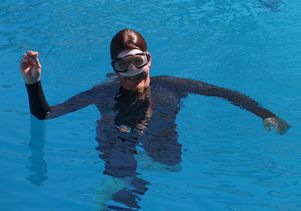 UCLA Facilities Management mechanic Chad Conrad holding an elephant earring he found at the bottom of a diving well.
