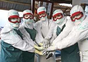 Waxman (second from right) and other volunteers broke a strict 'no-touch' rule in a show of team unity before starting rounds on a colleagues' last day at the Lunsar Ebola treatment unit.