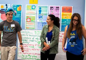 UCLA student Katherine Herrera (center) and her fellow UCLA students give a class presentation for a UCLA Labor Center course on applied research methods.