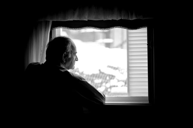 Man looking out window