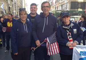 Two Operation Mend patients, Army Sergeant Karolyn Smith and Army Specialist (retired) Micah Krogstad participate in the parade with U.S. Army General (retired) Pete Chiarelli and nurse volunteer Patti Taylor.