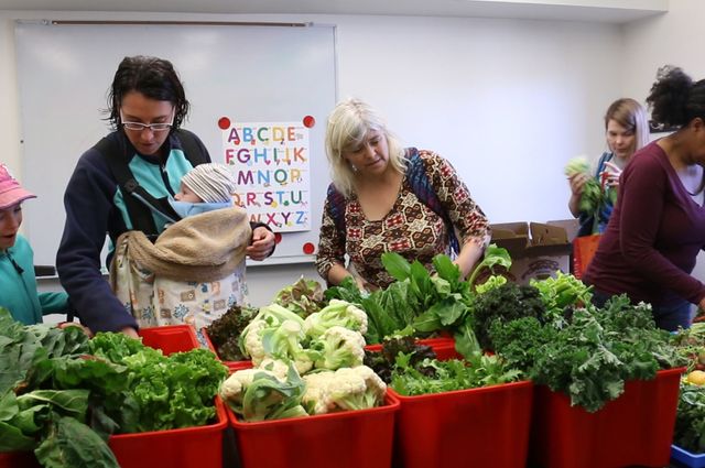 Graduate student families select produce at UCLA University Village