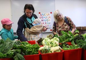 Rebecca Bork (middle) and her children, Ava and Finn, are among those who benefit from having fresh produce delivered by UCLA students to the UCLA University Village.