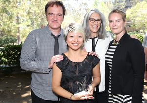 UCLA costume design graduate student Kumie Asai holds the 2016 Swarovski Shooting Star Award. With her are Quentin Tarantino, Deborah Landis and Elizabeth Murphy.