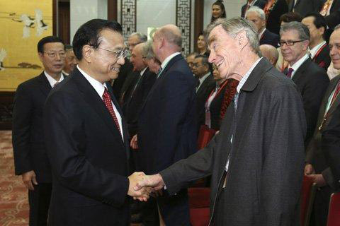 Chinese Premier Li Keqiang, at left, greets Dr. Roger Detels at the award ceremony in Beijing.