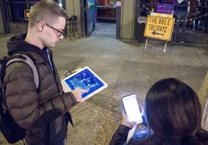 UCLA Luskin student researchers Ryan Dougherty and Christine Munoz use digital devices to establish a survey zone outside a club in West Hollywood.