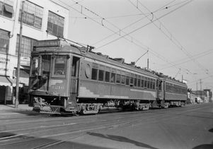 A Pacific Electric Railway Red Car is southbound on San Pedro Street in downtown Los Angeles on its way to Santa Ana in the 1940s.