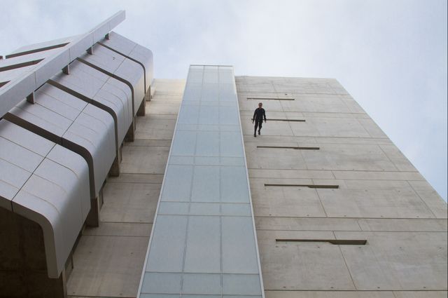 caption Man walking down side of Broad Art Center