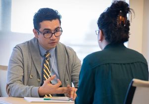Medical student Edgar Corona advises a student.