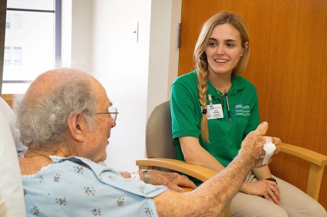 Volunteer companion Julia Torrano and a patient