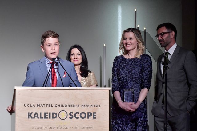 Honoree Kaii Davis Jarrahy speaks as Johnese Spisso, CEO of the UCLA Hospital System, and Kaii's parents, Geena Davis and Dr. Reza Jarrahy, look on.