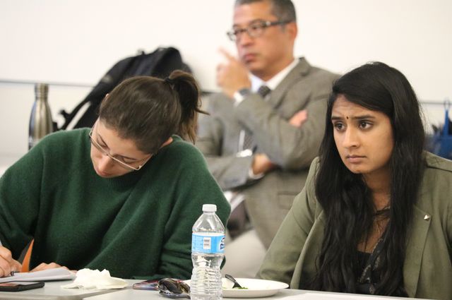 Medical students Samantha Mohammad, left, and Abhinaya Narayanan take notes during the social work orientation.