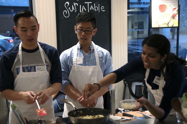 Dentistry student Joel Fong, medical student Billy Nguyen and public health student Eesha Jagtap apply their own finishing touches.