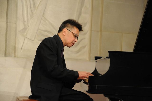 Jon Jang playing piano