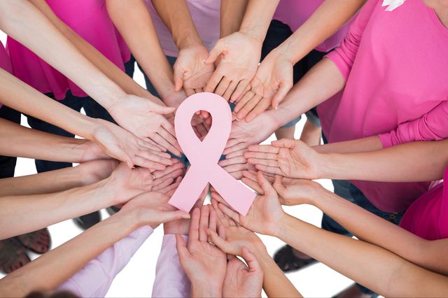 Hands and breast cancer ribbon