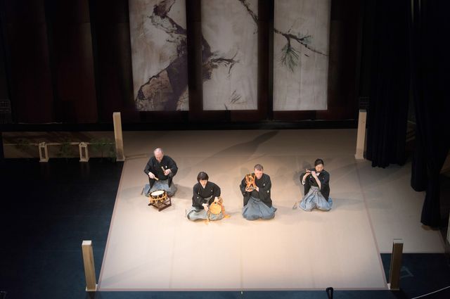 caption Still from the play Blue Moon Over Memphis, which features four people sitting on a spartan stage