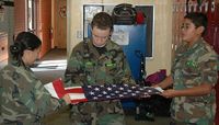 Students in the AIMS ZORT class learn basic flag folding skills as part of its leadership training. Photo credit: Steve Carr