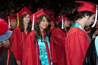 UNM graduates enter University Arena during the processional. Photo courtesy Bobby Tamayo Photography.