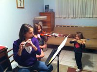 Eric Lau's wife Jennifer, who also teaches in the College of Fine Arts Department of Music plays along with daughters Madeleine, left, and Katherine, right.