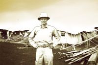 John Hodges poses for the camera in front of his quarters during WWII.