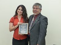 New Staff Council President Renee Delgado-Riley presents Gene Henley, past-president, with the UNM Staff Council Past President Award.