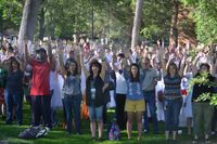Students prepare for the day with stretching and breathing exercises.