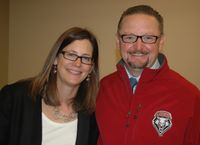 Parttime faculty in Anderson School of Management Kathy Towle, and her husband, Mauricio Ibarra Ponce de León, are pleased with the Lobo jacket Ibarra received from UNM Vice President for Student Affairs Eliseo "Cheo" Torres.