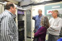 UNM team members Hays Barrett, Karl Benedict and John Savickas show the EPSCoR server, housed at the Earth Data Analysis Center to National Science Foundation officer Augrey Levine.