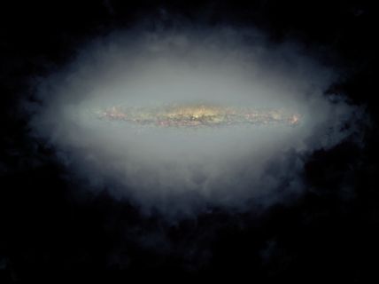 Composite image of an edge-on spiral galaxy with a radio halo produced by fast-moving particles in the galaxy's magnetic field. In this image, the large, grey-blue area is a single image formed by combining the radio halos of 30 different galaxies, as seen with the Very Large Array. At the center is a visible-light image of one of the galaxies, NGC 5775, made using the Hubble Space Telescope. This visible-light image shows only the inner part of the galaxy's star-forming region, outer portions of which extend horizontally into the area of the radio halo.