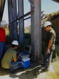 Civil Engineering Professor Arup Maji conducts tests with doctoral candidates Saman Rashidyan and Ali Mandawi on NM Highway 491 bridge.