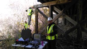 Civil Engineering Professor Arup Maji with graduate students Saman Rashidyan and Ali Mandawi conducting sonic echo tests on the timber foundation of a bridge over Rayado Creek near Springer, New Mexico.