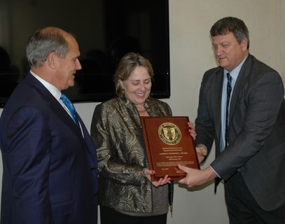 President Robert Frank (left) looks on proudly while DSS Chief James Dixon (far right) presents UNM Industrial Security Manager Deb Kuidis with the 2016 James S. Cogswell Outstanding Industrial Security Achievement Award. Award presentation