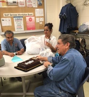 Irvin Romero, right, enjoys a break with some colleagues. Romero has been working on the UNM campus for 50 years. Irvin Romero