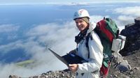 Tobias Fischer collects measurements of volcanic sulfur dioxide in the sky overhead using a Differential Optical Absorption Spectrometer on the summit of Kanaga volcano in the Western Aleutian Islands. Tobias-Fischer