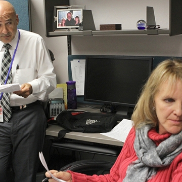 Dr. Chris Camarata, left, and palliative care nurse Kim Harlow, discuss cases during a recent palliative care team meeting at UNM Hospital.