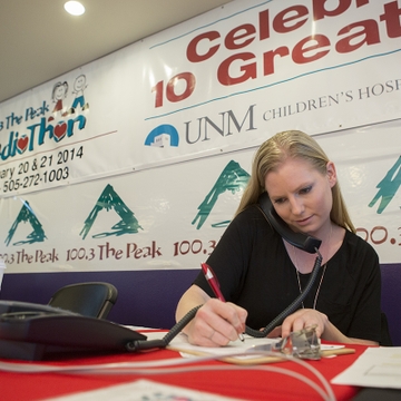 Volunteer Amanda McKethan takes calls during the 2014 radiothon at UNM Children's Hospital.