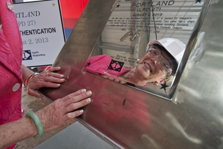 Mrs. Bonnie Amos, wife of U.S. Marine Corps Gen. James Amos, Commandant of the Marine Corps and ship sponsor of Portland (LPD 27), looks at the ceremonial keel plate with her initials that will remain with LPD 27 during the ship's entire Naval service. Photo by Lance Davis Mrs. Bonnie Amos authenticates keel of Portland (LPD 27)