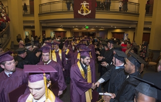 Graduates of Newport News Shipbuilding's Apprentice School file out of the Worship Center at Liberty Baptist Church following commencement exercises on Saturday, March 1, 2014. Photo by Ricky Thompson Newport News Shipbuilding Apprentice School Graduation
