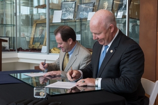 John R. Broderick (left) and Danny Hunley sign a memorandum of understanding between Old Dominion University and Newport News Shipbuilding to offer a new bachelor’s degree program in mechanical and electrical engineering at The Apprentice School. Broderick serves as president of ODU; Hunley serves as Newport News’ vice president of operations. Photo by Chris Oxley/HII Broderick, Hunley Sign Memorandum of Understanding
