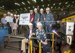 Paul and Nancy Ignatius (seated) attended the start of fabrication ceremony for Paul’s namesake ship, the guided missile destroyer DDG 117. Also pictured (left to right): Lance Carnahan, Ingalls’ general hull superintendent; Robert Velazquez, friend of the Ignatius family; David Ignatius, Paul and Nancy’s son; Dr. Elisa Ignatius, Paul and Nancy’s granddaughter and Nancy’s maid of honor as the ship’s sponsor; Sarah Ignatius, Paul and Nancy’s daughter; George Nungesser, Ingalls’ DDG 51 program manager; Capt. Mark Vandroff, DDG 51 class program manager, Program Executive Office Ships; Cmdr. Ben Wilder, DDG 51 program manager representative for Supervisor of Shipbuilding Gulf Coast; and Rear Adm. David J. Gale, deputy commander for surface warfare, Naval Sea Systems Command. Photo by Lance Davis/HII Paul Ignatius Start of Fabrication Ceremony
