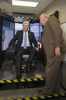 Mississippi Governor Phil Bryant tried his hand in a crane simulator during a tour of Ingalls Shipbuilding’s Maritime Training Academy today. Also pictured is Larry Porter, a master trainer at Mississippi Gulf Coast Community College, which partners with Ingalls and the State of Mississippi in administering Ingalls’ apprenticeship program. Photo by Andrew Young/HII Mississippi Governor Visits Ingalls Shipbuilding