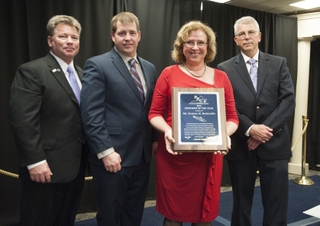 Suzanne Beckstoffer accepts the Virginia Peninsula Engineer of the Year award from (from left to right) Gary Fuller, president of the Peninsula Engineers Council (PEC); Scott Opdyke, representative from the Society of Naval Architects and Marine Engineers (SNAME), the society that nominated Beckstoffer; and Ken Hoffman, the PEC Engineer of the Year committee chair. Photo by Dar Mook/HII Suzanne Beckstoffer Receives Virginia Peninsula Engineer of the Year Award