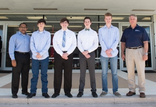 Ingalls Shipbuilding presented National Merit Scholarships to four students on July 1, 2015. Pictured (left to right) are Edmond Hughes, Ingalls’ vice president, human resources and administration; James Stork Jr., Bryant High School; Cameron Gruich, St. Martin High School; William Hagar, Baker High School; Peter Kooienga, Ocean Springs High School; and Ingalls Shipbuilding President Brian Cuccias. Photo by Andrew Young/HII Ingalls Awards Merit Scholarships