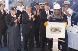 Leon Walston, a Newport News Shipbuilding welder from Massachusetts, displays the welded initials of Caroline Kennedy, the sponsor of the aircraft carrier John F. Kennedy (CVN 79). Also pictured (left to right) are Rear Adm. Earl Yates, the first commanding officer of the aircraft carrier USS John F. Kennedy (CV 67); Newport News Shipbuilding President Matt Mulherin; Virginia Gov. Terry McAuliffe; and Rep. Joseph Kennedy. Photo by Chris Oxley/HII Kennedy Keel Laid